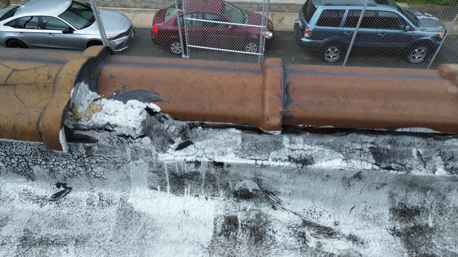 Deteriorated copper vent pipe flashing on a flat roof in Union City, NJ