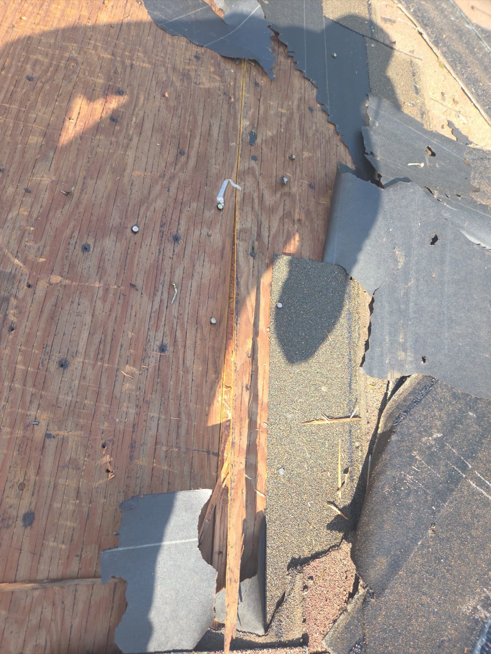 Decking inspection after shingle removal during a New Jersey roof replacement by Zubar Roofing.