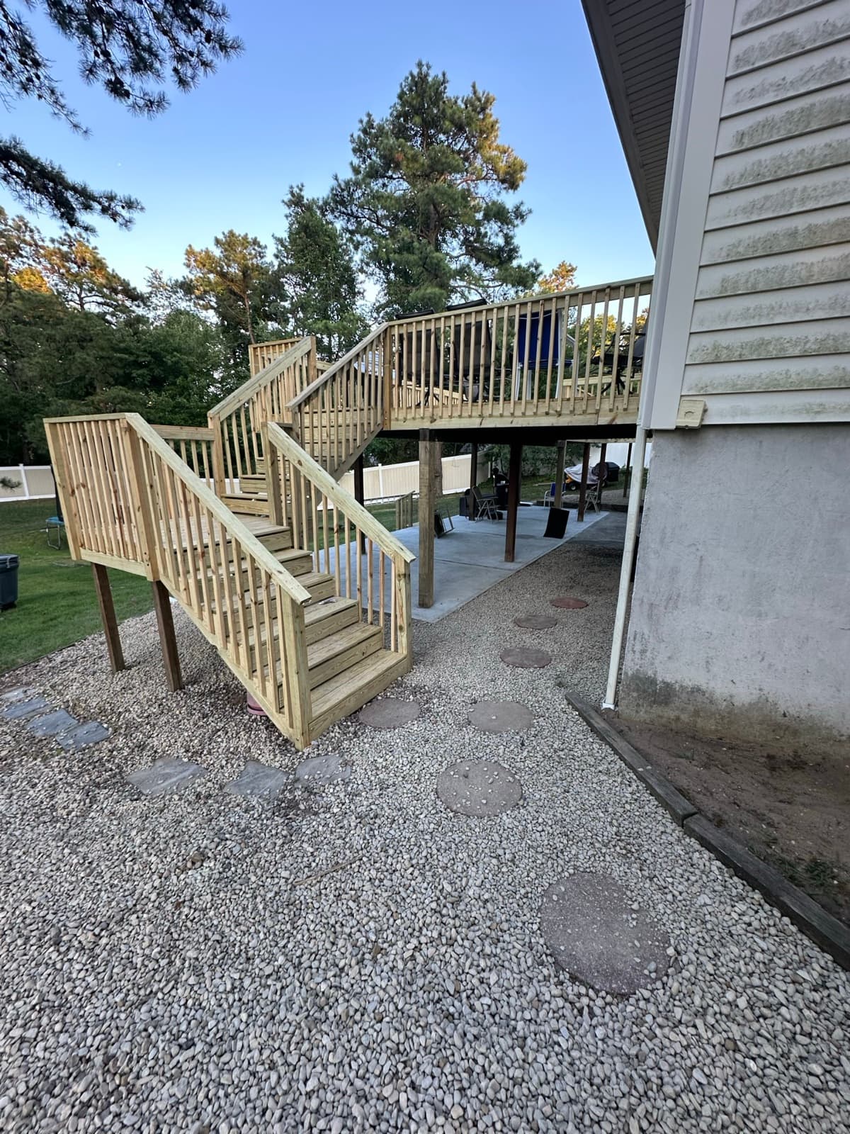 Exterior wood deck with stairs and railing built by Zubar Roofing in New Jersey.