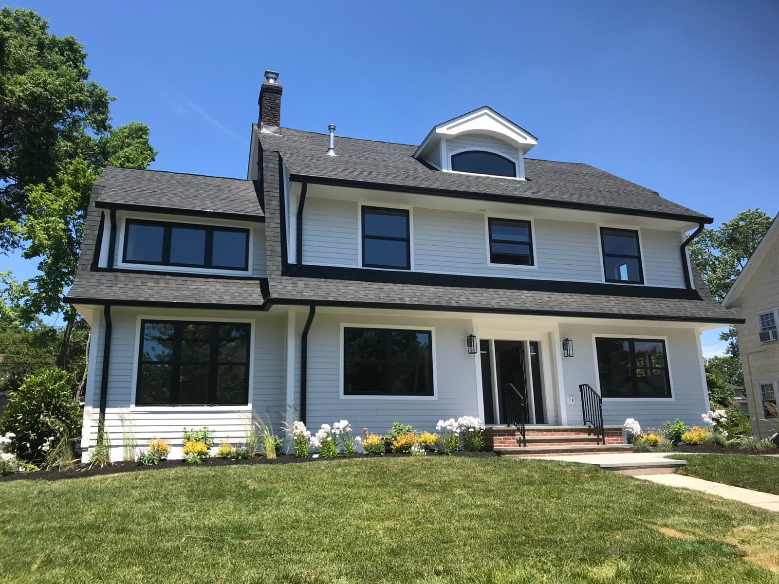 Architectural shingle roof on a white colonial — full replacement in New Jersey by Zubar Roofing.