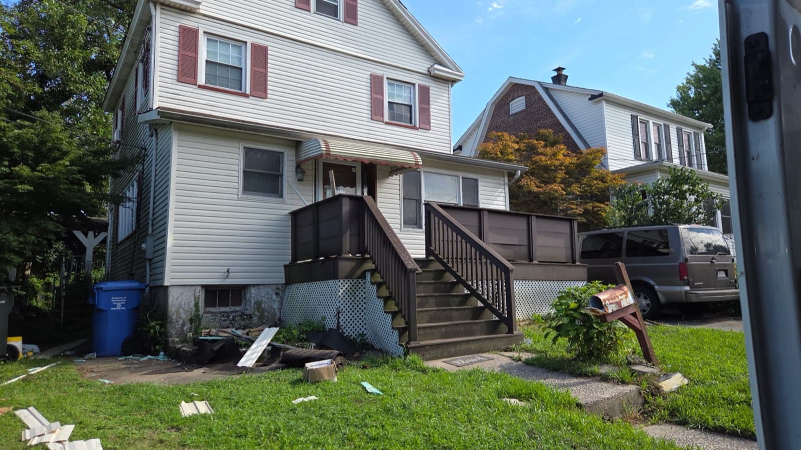 New Jersey two-story home with new vinyl siding and a shingle roof by Zubar Roofing.