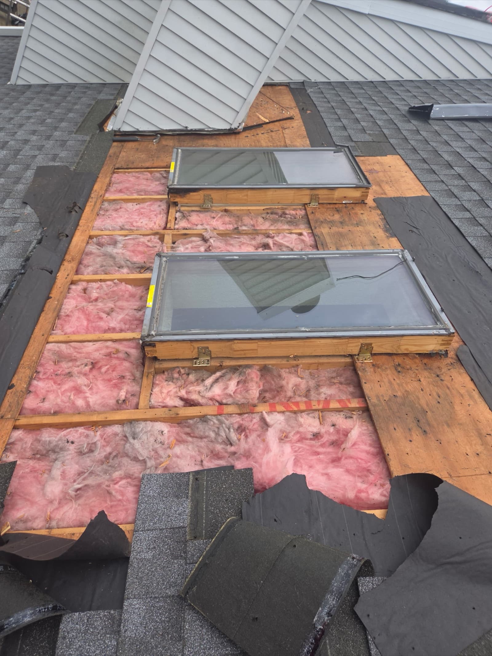 Velux skylight curb-mount installation with proper flashing kit and insulation on a New Jersey asphalt shingle roof.