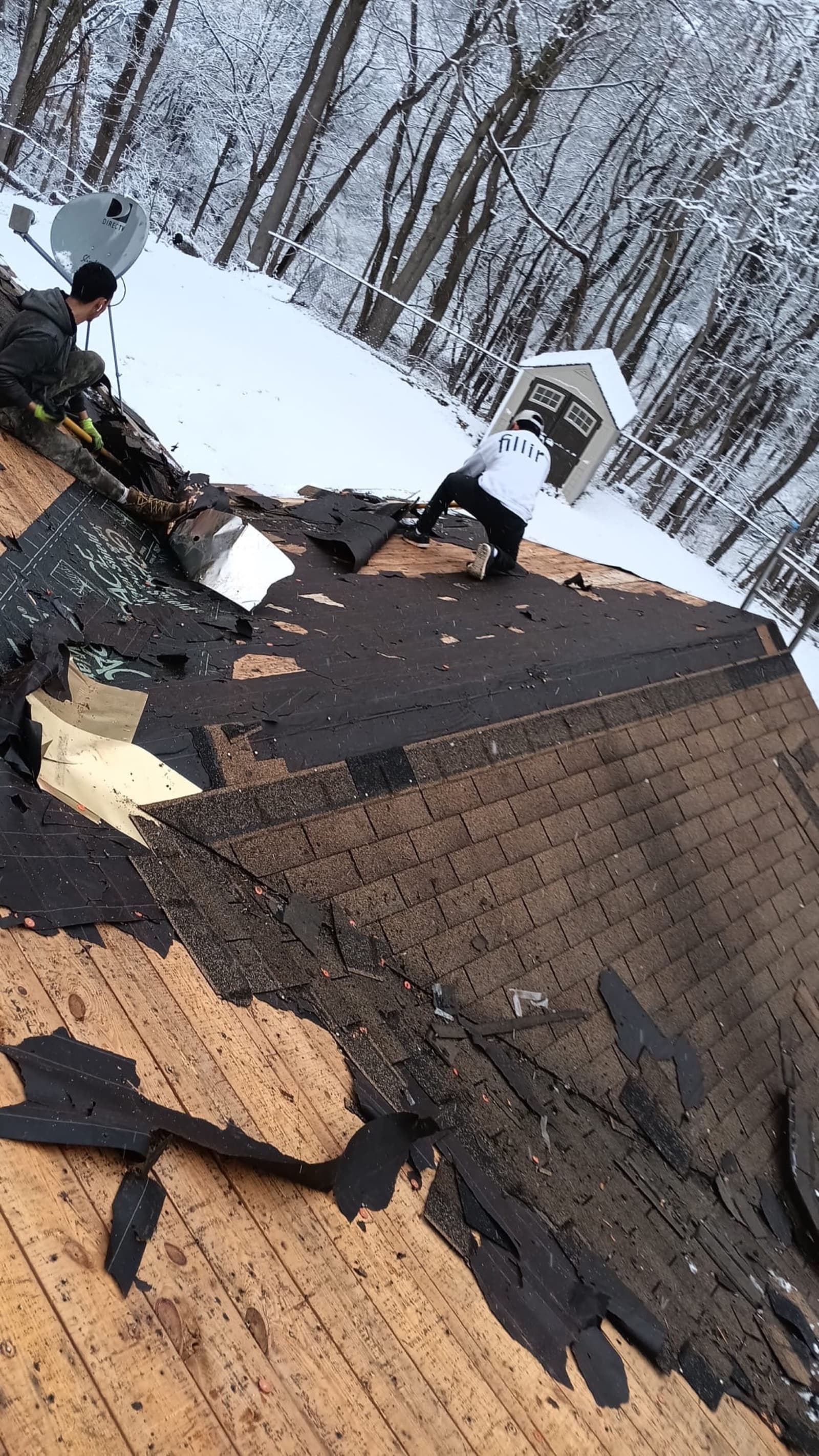 Emergency storm-damage roof tear-off in winter — Zubar Roofing documenting and replacing wind damage.
